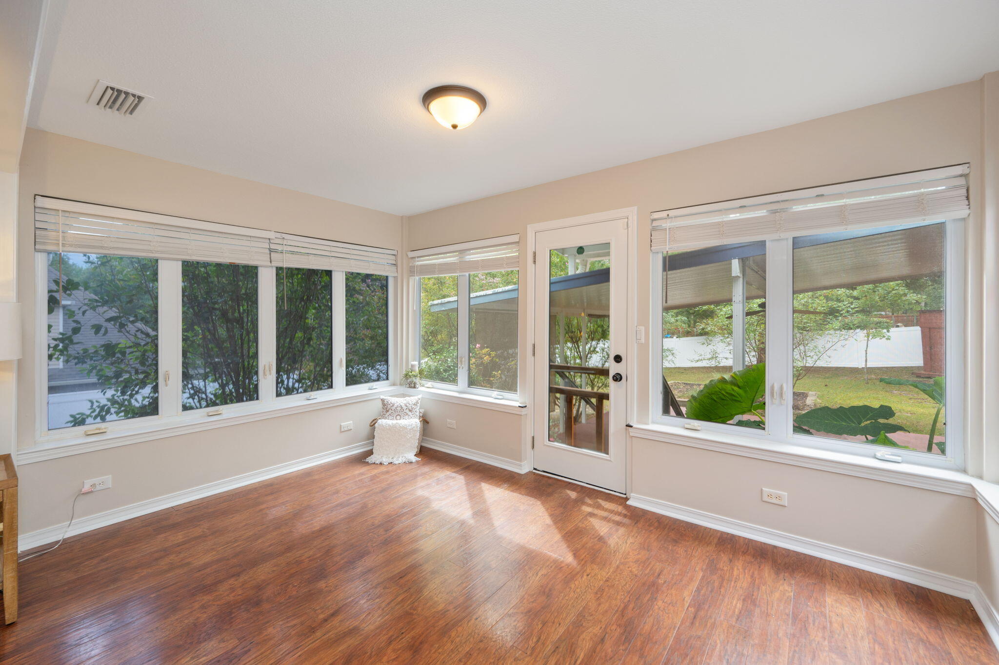 109 Eagle Drive Crestview, FL 32536 - Photo 13 of 52 a view of an empty room with wooden floor and a window