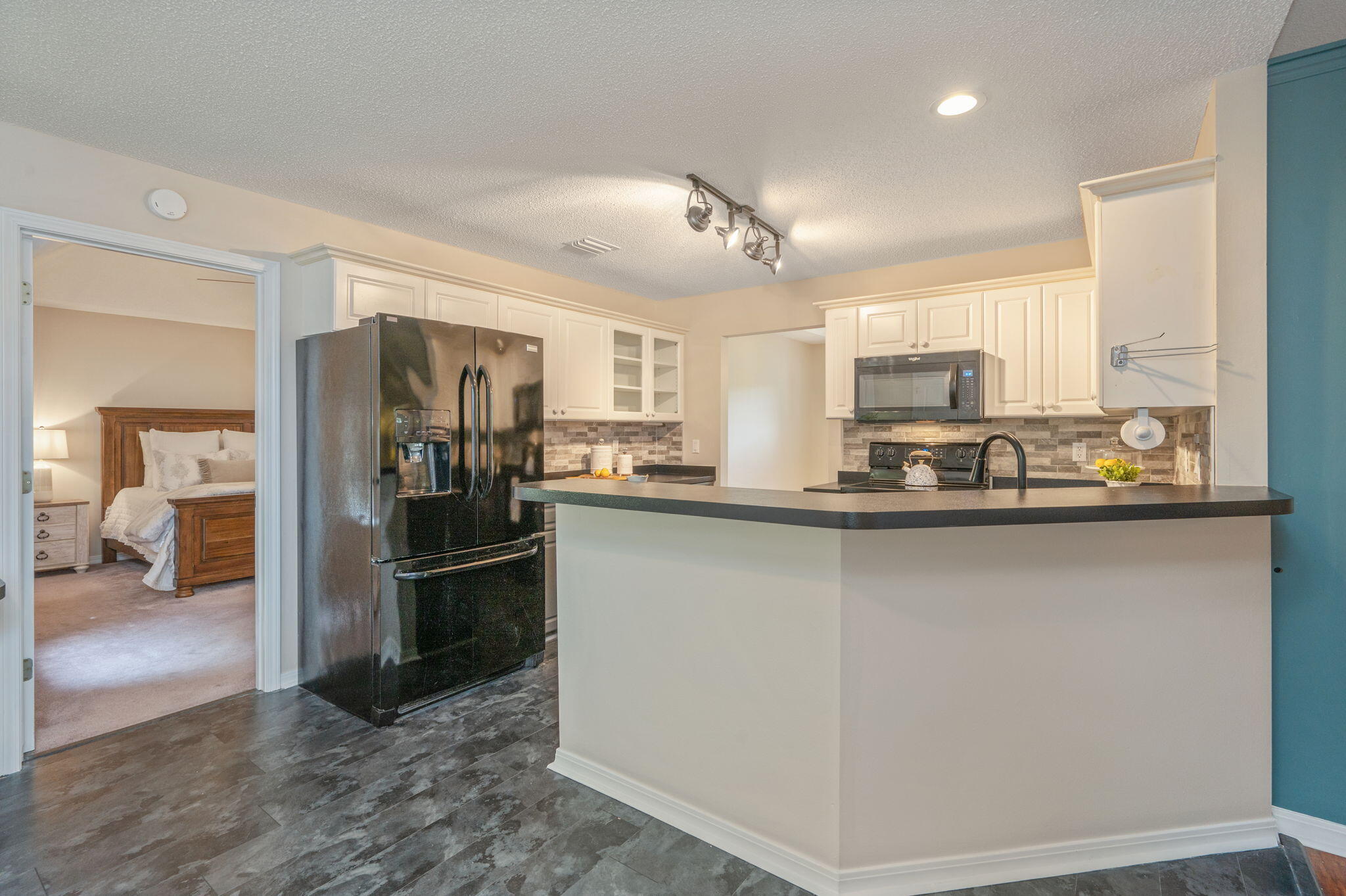 109 Eagle Drive Crestview, FL 32536 - Photo 17 of 52 a kitchen with granite countertop a refrigerator stove and sink