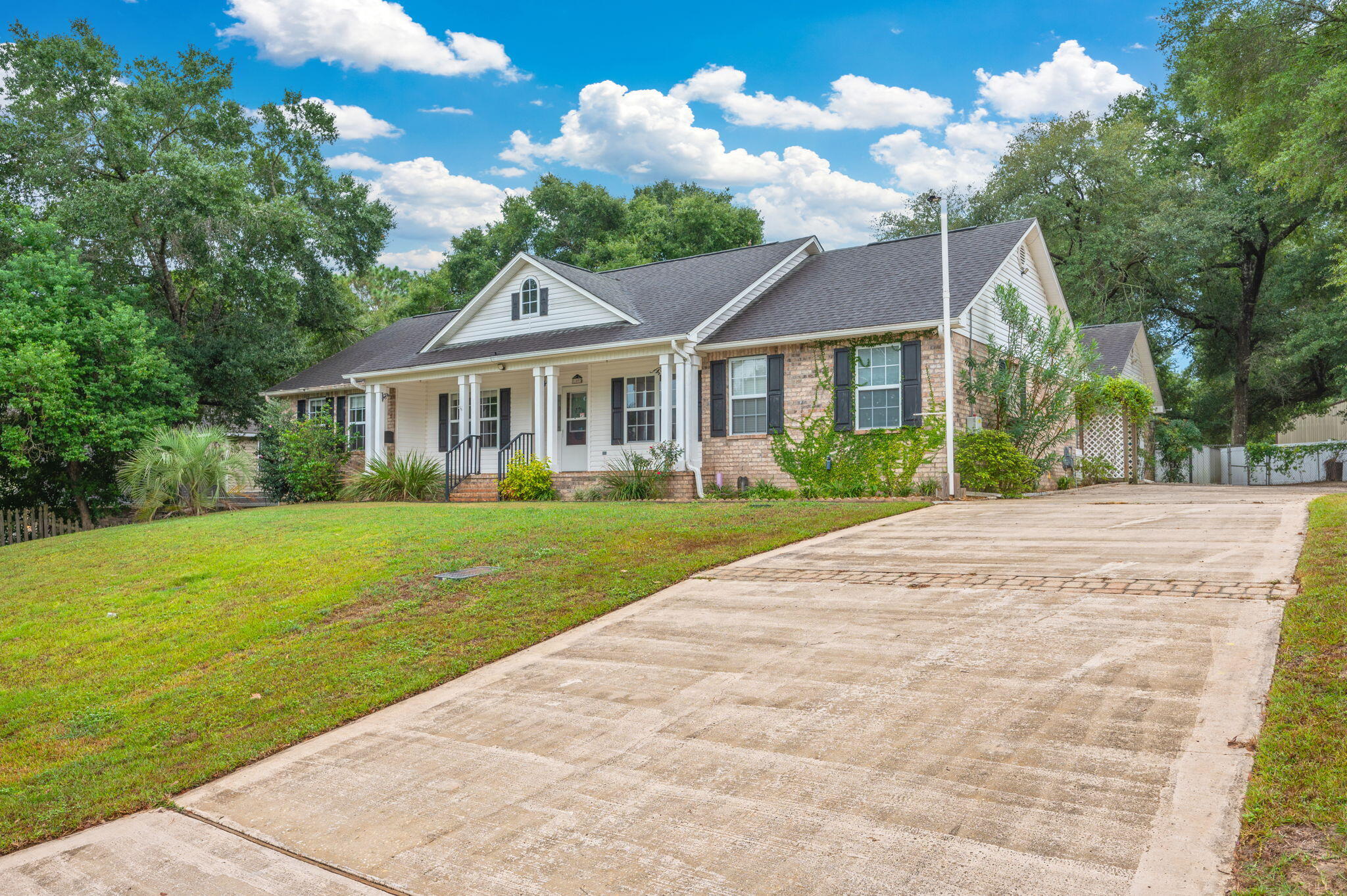 109 Eagle Drive Crestview, FL 32536 - Photo 2 of 52 a front view of a house with garden