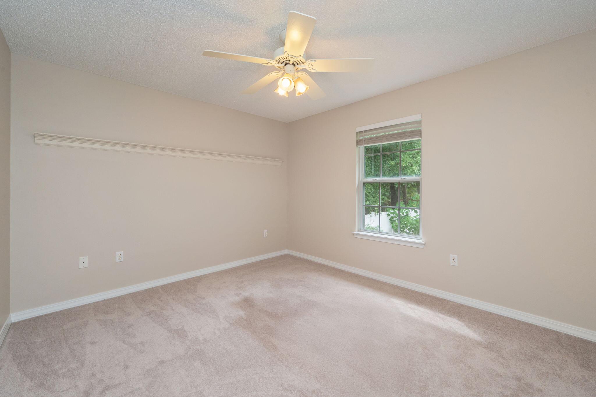 109 Eagle Drive Crestview, FL 32536 - Photo 32 of 52 an empty room with a window and a ceiling fan