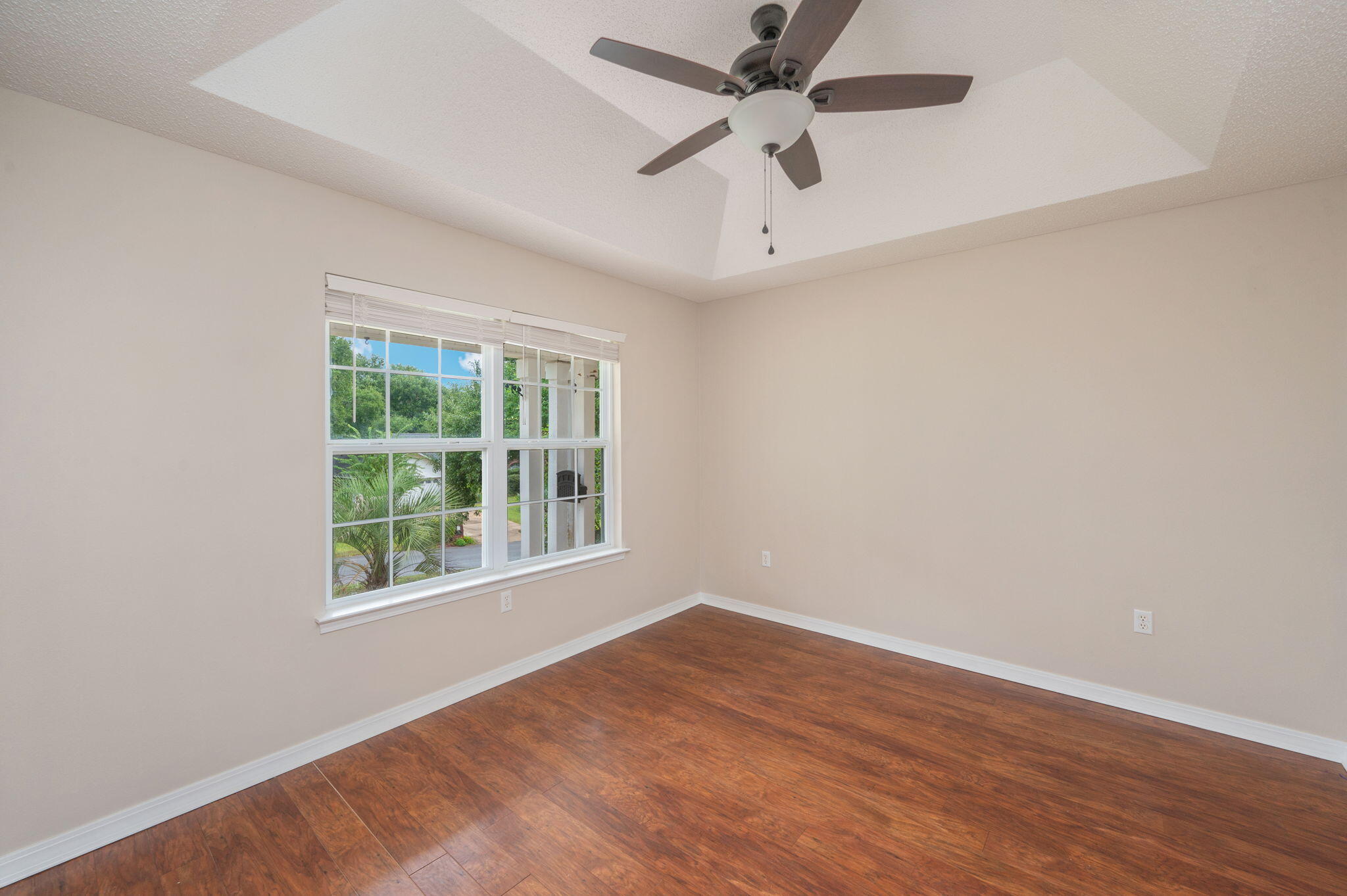 109 Eagle Drive Crestview, FL 32536 - Photo 40 of 52 an empty room with wooden floor ceiling fan and windows