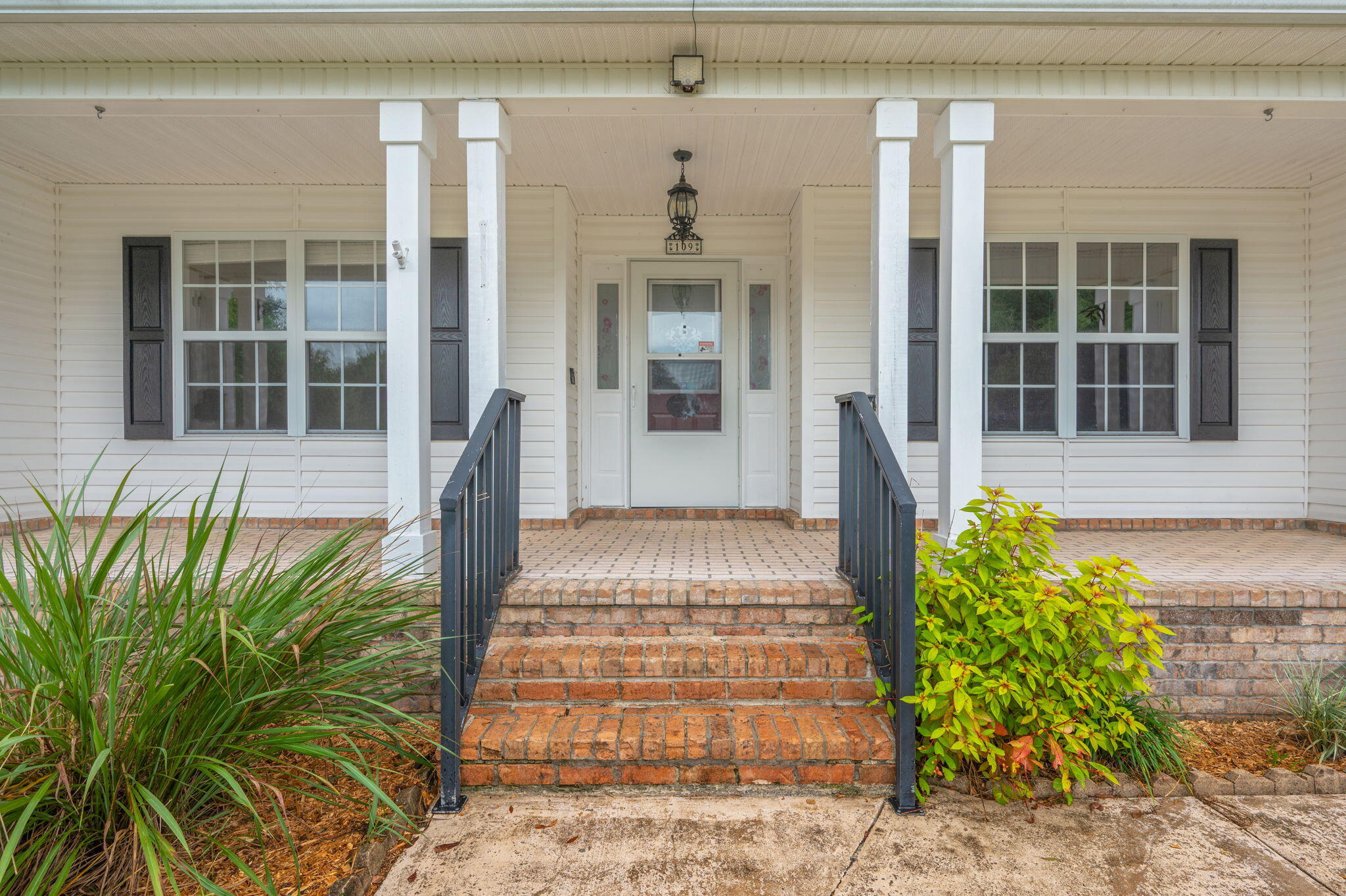 109 Eagle Drive Crestview, FL 32536 - Photo 4 of 52 a front view of a house with garden