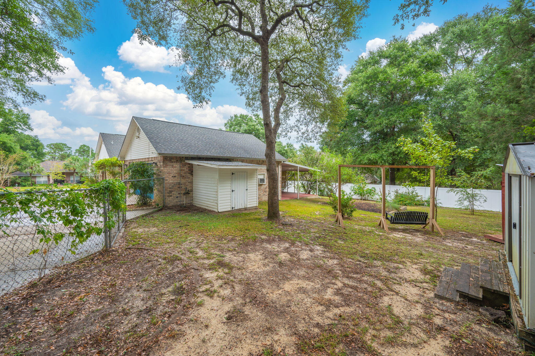 109 Eagle Drive Crestview, FL 32536 - Photo 48 of 52 a view of a house with a backyard and a tree