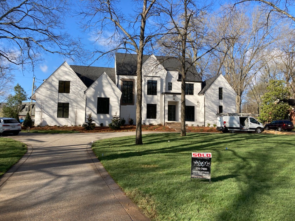 a front view of a house with a yard table and chairs