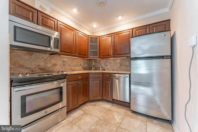 a kitchen with stainless steel appliances granite countertop cabinets and sink