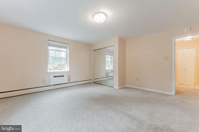 an empty room with windows and entrance