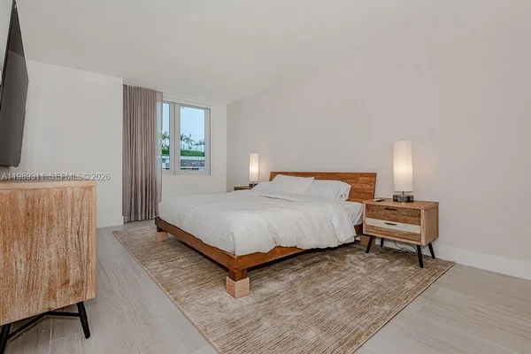 a bedroom with a bed and window