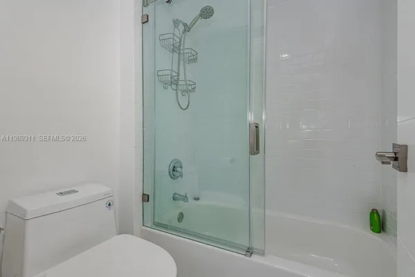 a bathroom with a shower a toilet and a shower