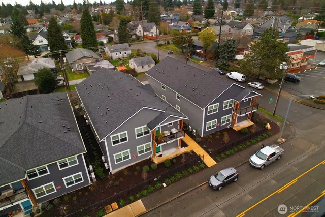an aerial view of multiple houses with yard