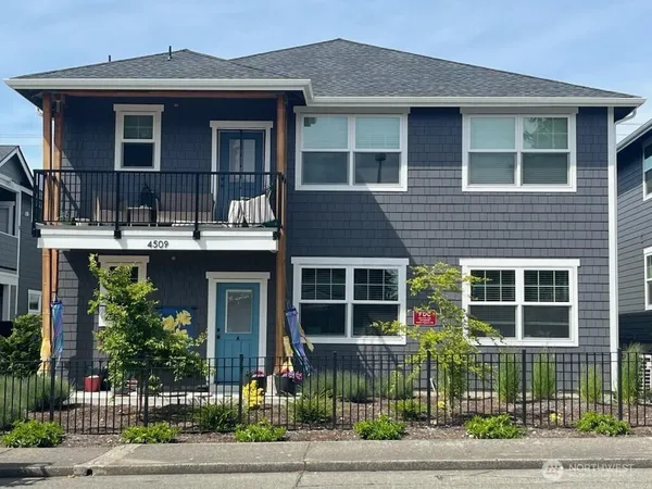 a front view of a house with a garden and plants