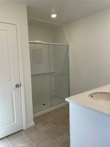 a bathroom with a shower and a sink