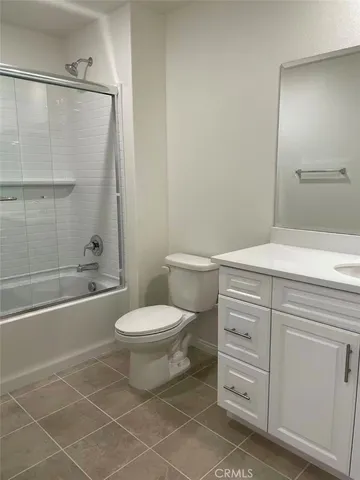 a bathroom with a toilet a sink and shower