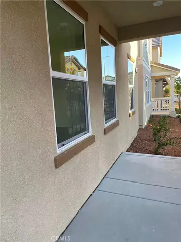 a view of a brick house with a large window