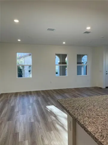 a view of a kitchen and an empty room