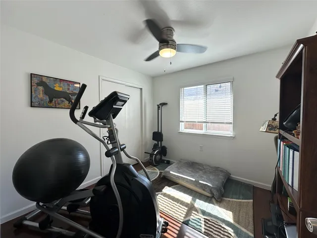 a room with gym equipment and windows