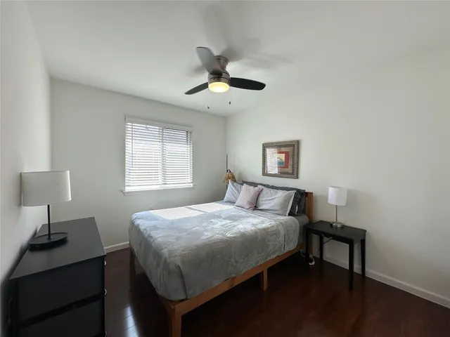 a bedroom with a bed and a desk