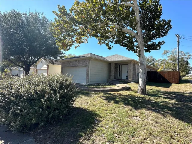 a house that has a tree in front of it