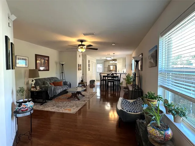 a living room with furniture and wooden floor