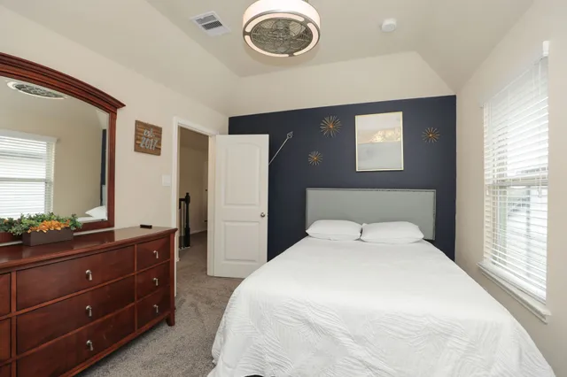 a dining room with furniture and a flat screen tv