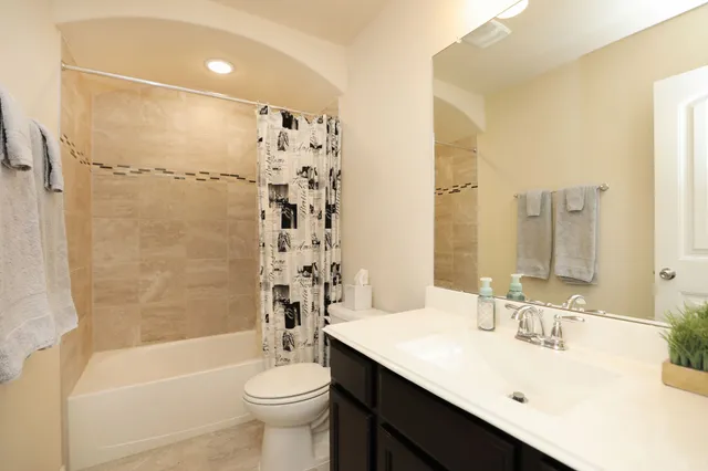 a view of a house with yard and chairs