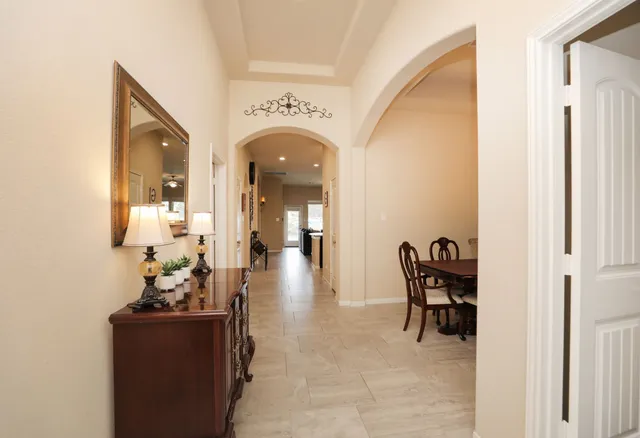 a view of a livingroom with wooden floor and a bathroom