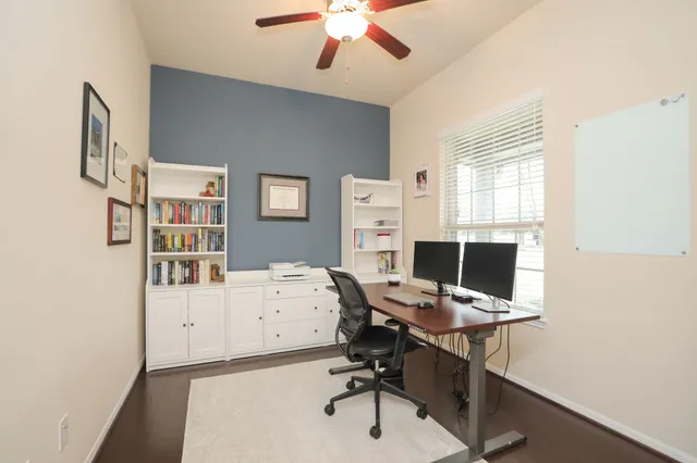 a view of a dining room with furniture and a window