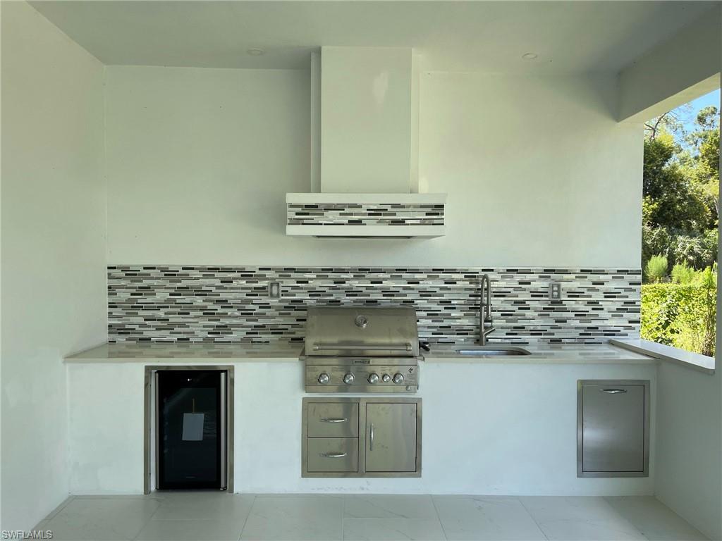 3203 68th Street Southwest Naples, FL 34105 - Photo 31 of 34 a kitchen with stainless steel appliances granite countertop a stove and a sink