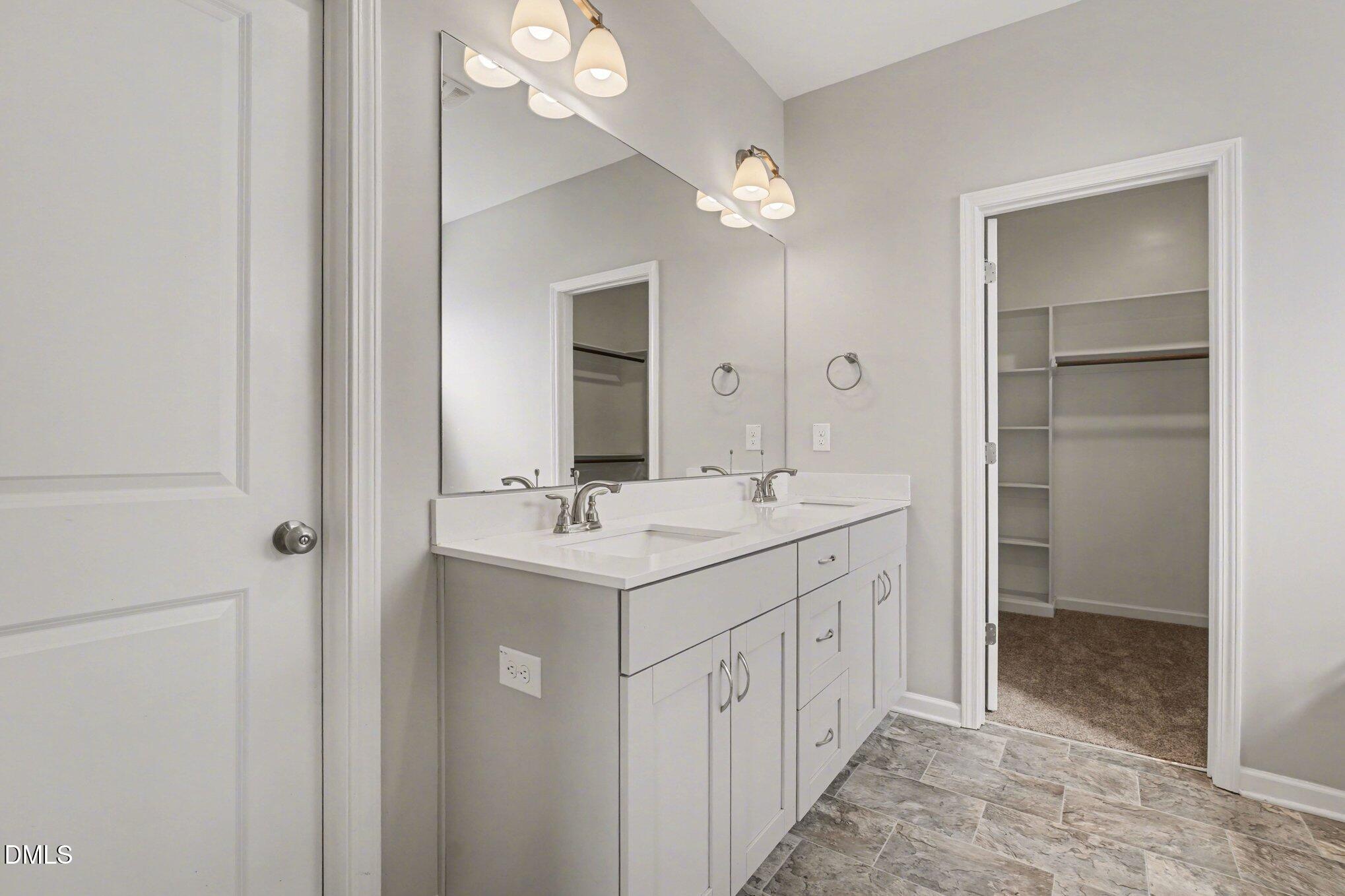 106 Two Daughters Streme Smithfield, NC 27577 - Photo 16 of 25 a bathroom with a double vanity sink a and mirror