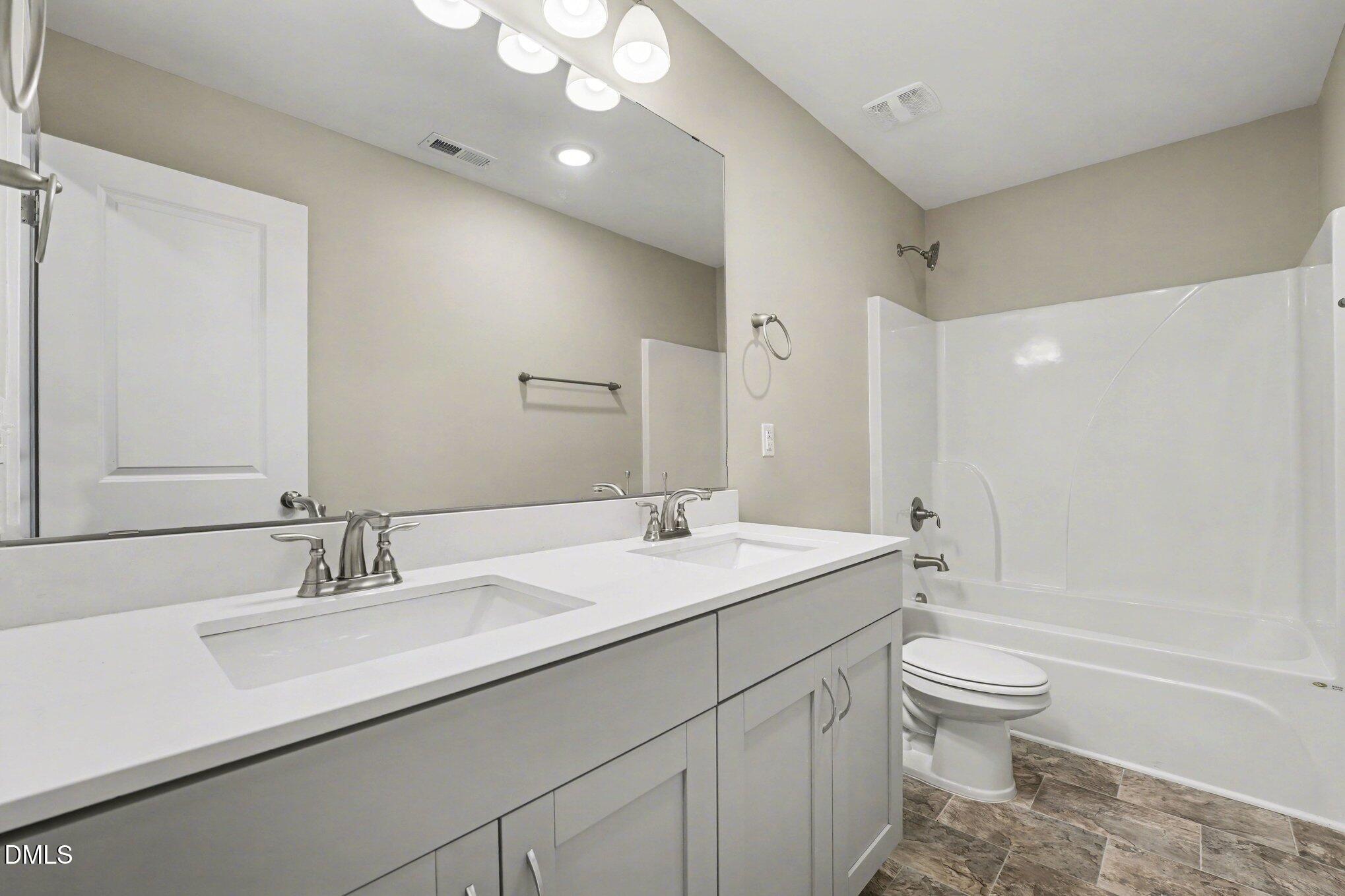 106 Two Daughters Streme Smithfield, NC 27577 - Photo 18 of 25 a bathroom with a granite countertop sink a toilet and shower