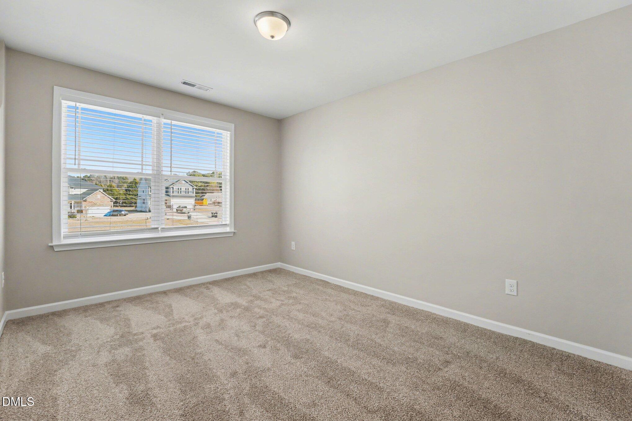 106 Two Daughters Streme Smithfield, NC 27577 - Photo 20 of 25 an empty room with windows
