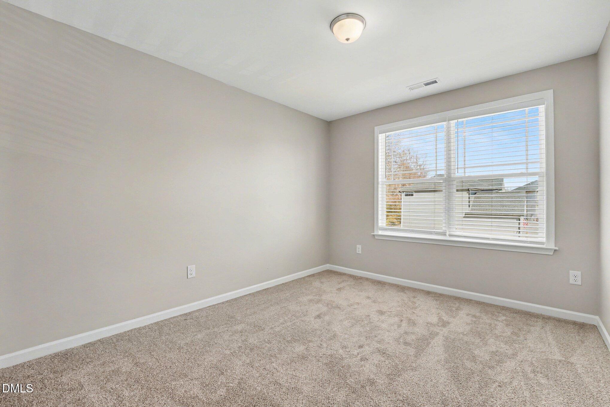 106 Two Daughters Streme Smithfield, NC 27577 - Photo 22 of 25 an empty room with windows