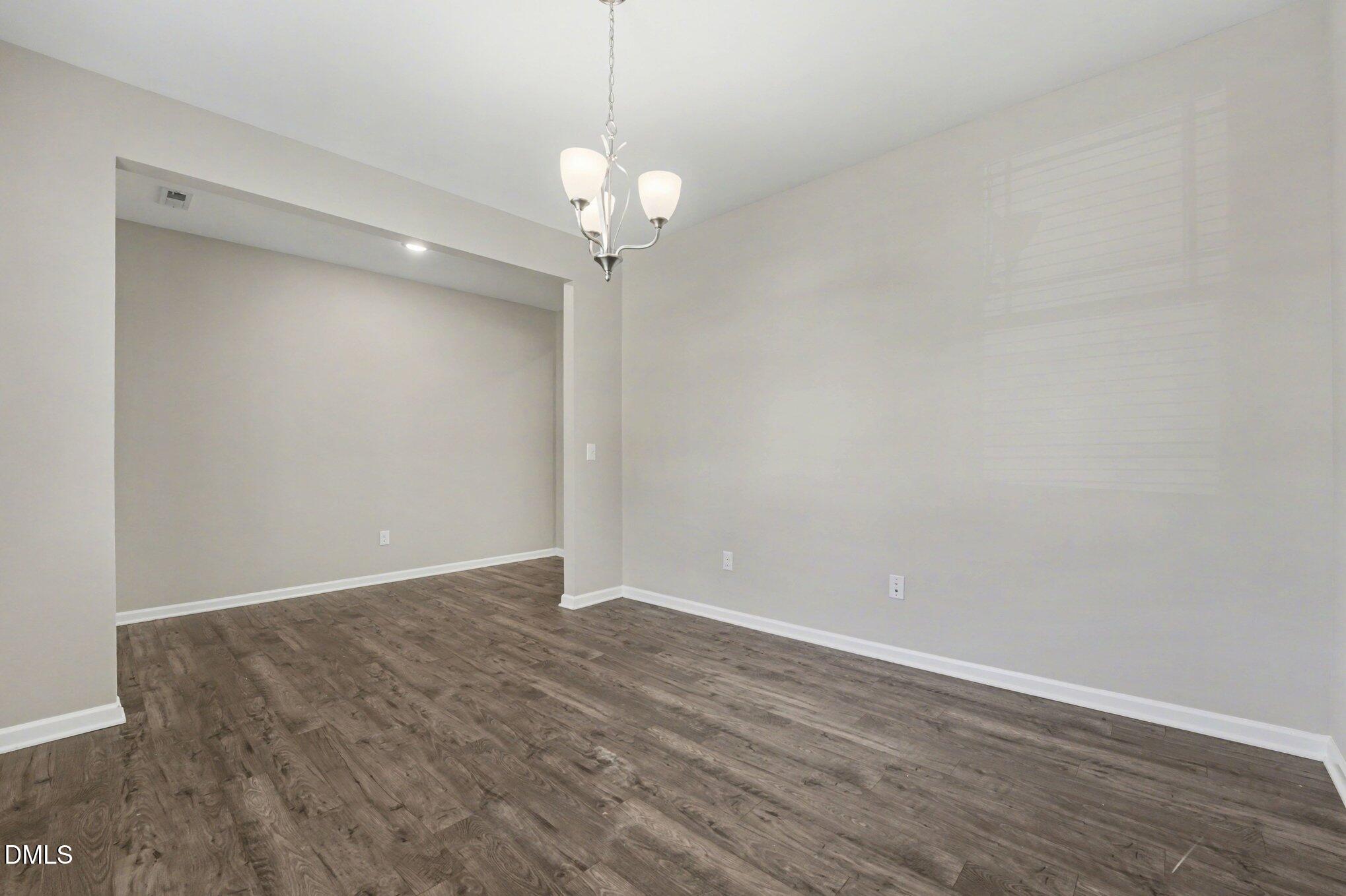 106 Two Daughters Streme Smithfield, NC 27577 - Photo 7 of 25 a view of an empty room with wooden floor