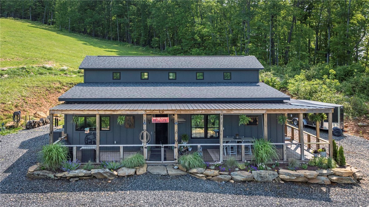 509 Grant Houck Road Todd, NC 28684 - Photo 5 of 43 a front view of a house with garden