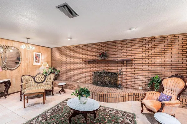 a dining hall with stainless steel appliances kitchen island granite countertop a dining table and chairs