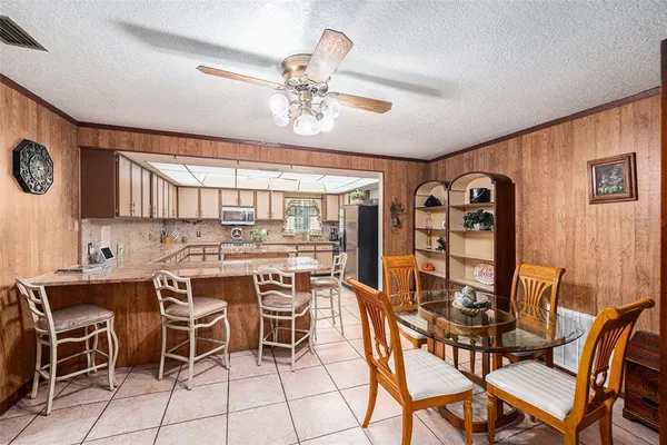 a view of a kitchen with refrigerator and microwave