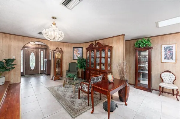 a view of a dining room with furniture and chandelier