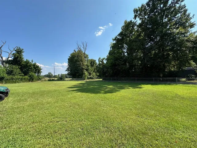 a view of a field of grass and trees