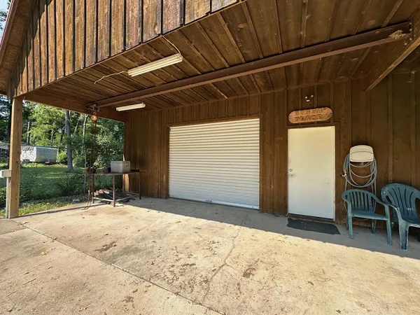 a backyard of a house with table and chairs
