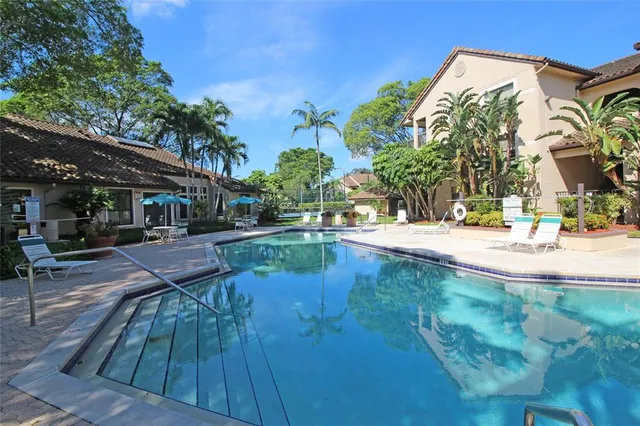 a view of a swimming pool with sitting area