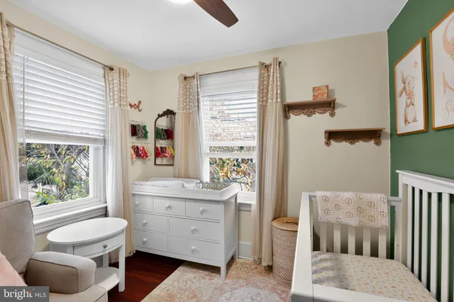 a view of a bedroom with furniture and windows