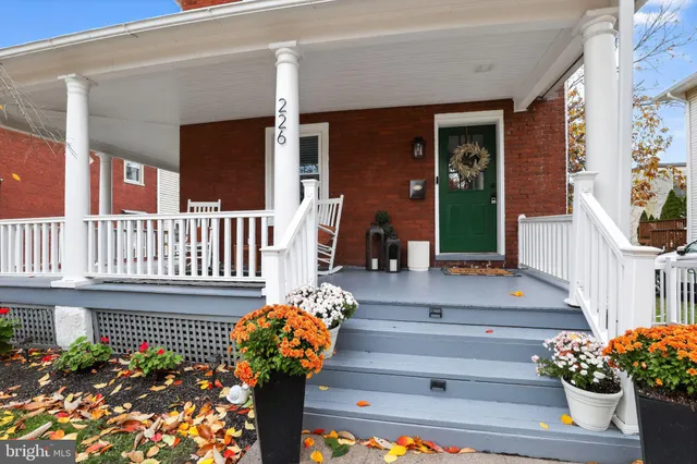 a front view of a house with flower garden