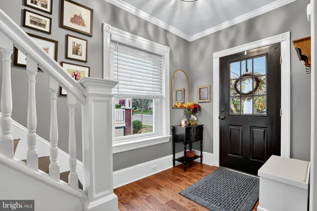 a living room with furniture a window and a potted plant