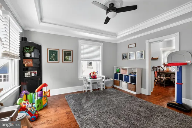 a living room with furniture a rug and gym equipment