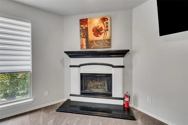 a living room with a fireplace and a window