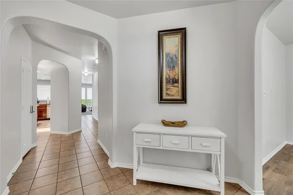 a view of room with painting on the wall and a potted plant