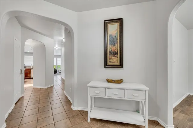 a view of room with painting on the wall and a potted plant