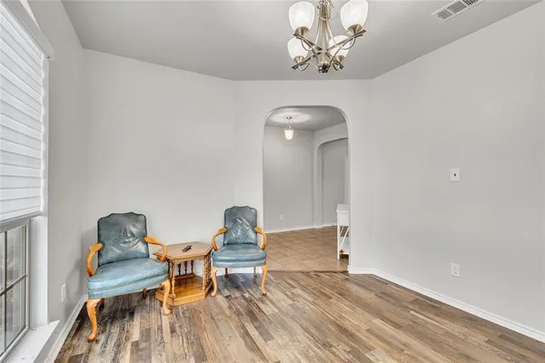 a view of a workspace with furniture and wooden floor