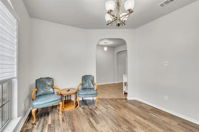 a view of a workspace with furniture and wooden floor