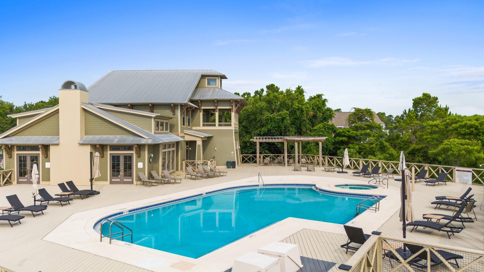 102 Turtle Cove Panama City Beach, FL 32413 - Photo 29 of 42 a view of a house with pool and chairs