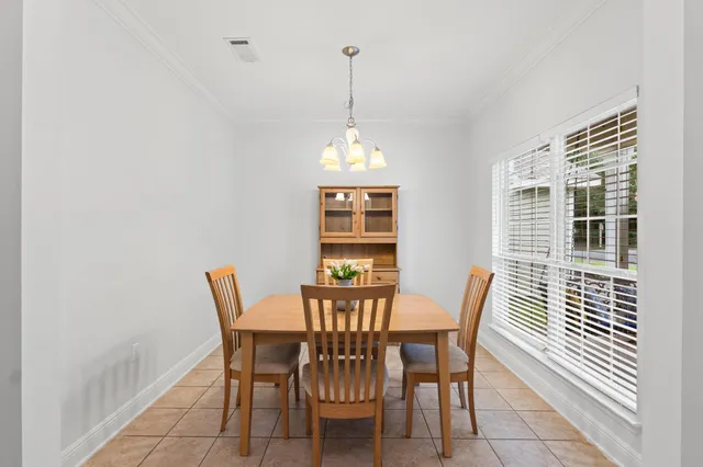 a view of a dining room with furniture wooden floor and a chandelier